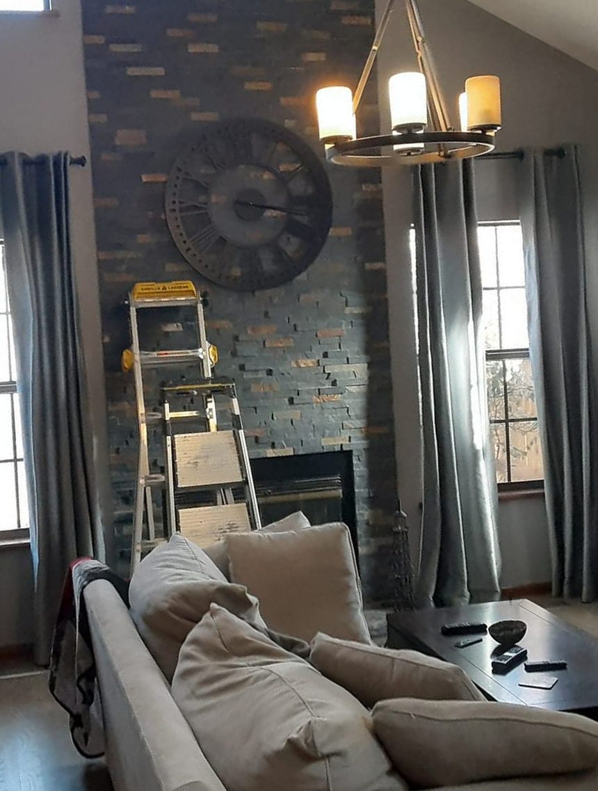 Interior painting in a vaulted living room with a stone fireplace by Rock's Finest Finishes