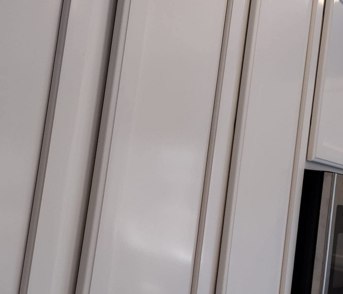 Close-up of a smooth sprayed white cabinet finish